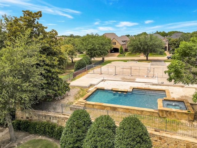 view of swimming pool with an in ground hot tub, a fenced backyard, and a fenced in pool