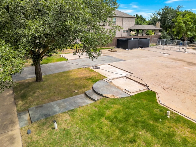 view of front of house with a patio, a hot tub, and a front yard