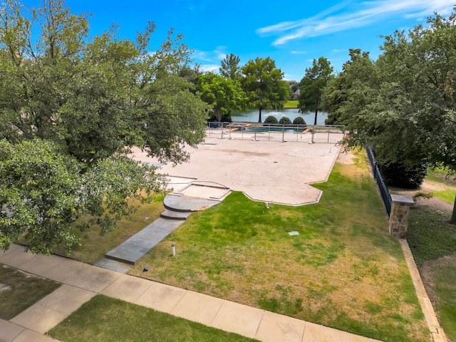 view of community featuring a lawn and a water view