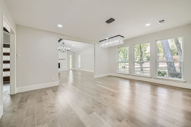 interior space with light wood-type flooring and a notable chandelier