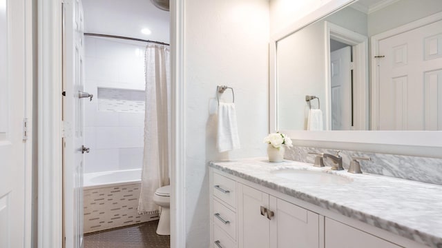 full bathroom featuring vanity, shower / tub combo with curtain, and toilet