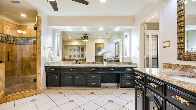 bathroom with ornamental molding, vanity, and a shower with shower door