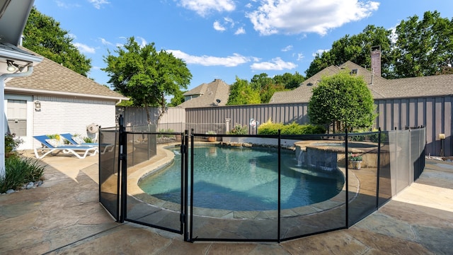 view of swimming pool with an in ground hot tub and a patio