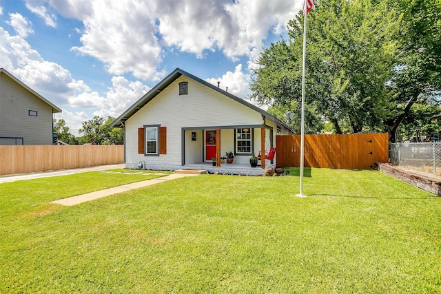 view of front of property with covered porch and a front yard