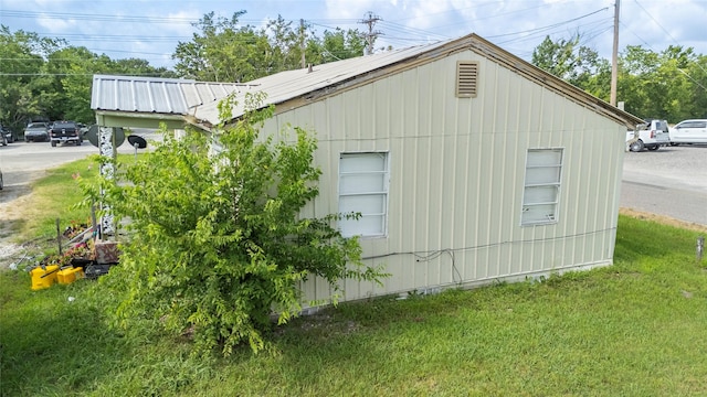 view of property exterior with a yard