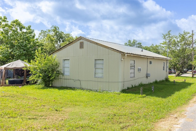 view of property exterior featuring a lawn