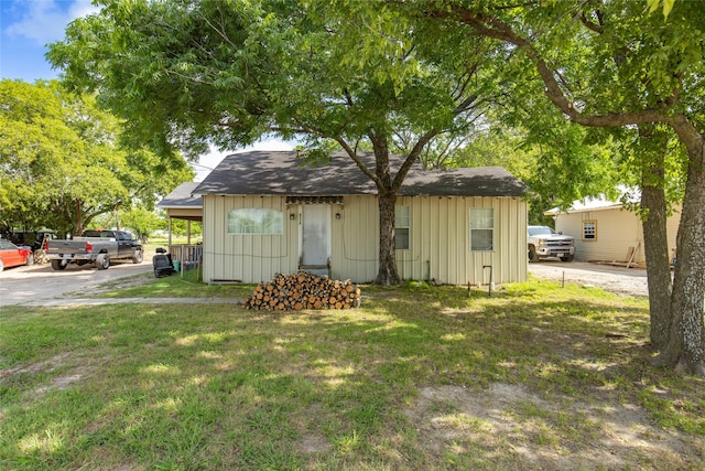 view of outbuilding featuring a lawn