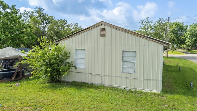 view of side of property with a lawn and central AC unit