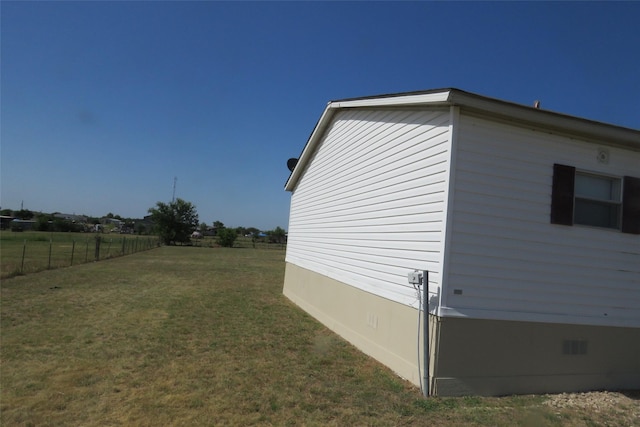 view of side of home with a yard