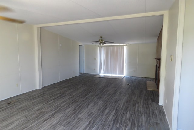 spare room featuring dark wood-type flooring and ceiling fan