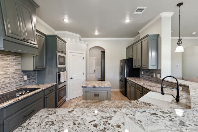 kitchen featuring sink, tasteful backsplash, light wood-type flooring, and stainless steel appliances