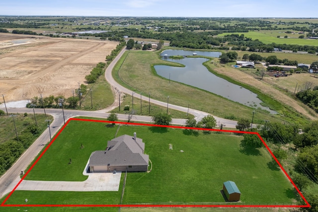 birds eye view of property with a rural view and a water view