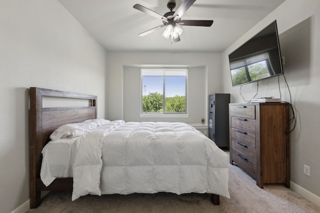 bedroom with light carpet, multiple windows, and ceiling fan