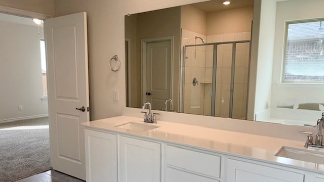 bathroom featuring vanity and an enclosed shower