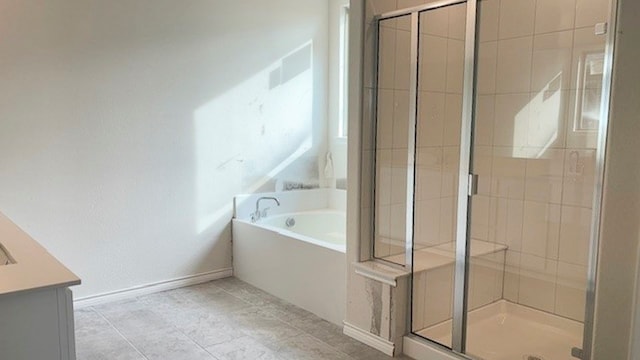 bathroom featuring vanity, plus walk in shower, and tile patterned floors