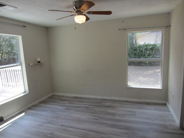 empty room with ceiling fan and hardwood / wood-style floors