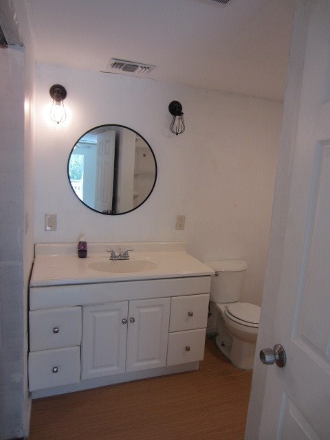 bathroom featuring toilet and vanity