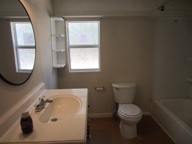 full bathroom featuring toilet, bathtub / shower combination, plenty of natural light, and vanity