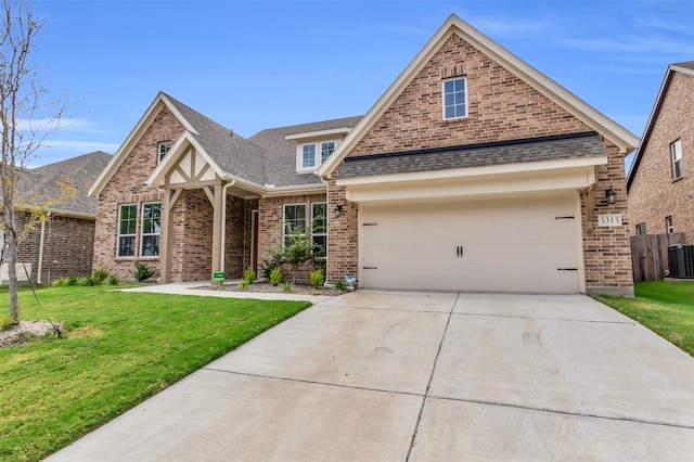 view of front of property with a front yard and a garage