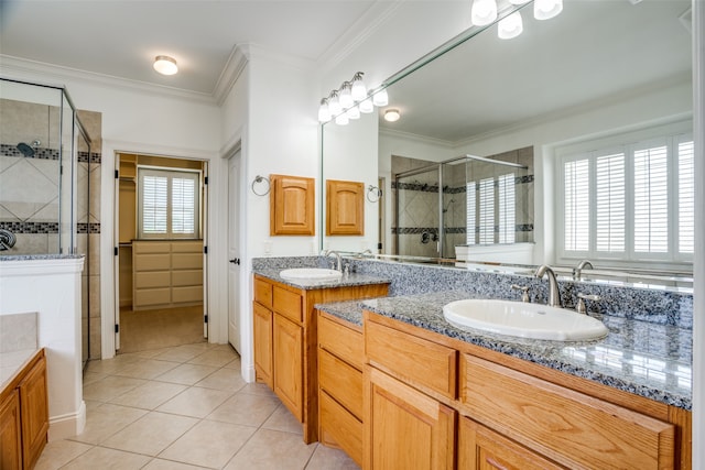 bathroom featuring a wealth of natural light, double sink vanity, and tile patterned flooring