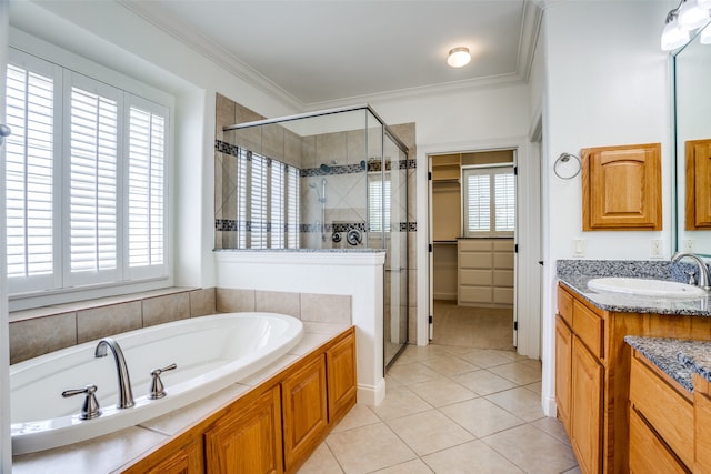 bathroom with vanity, tile patterned floors, shower with separate bathtub, and crown molding