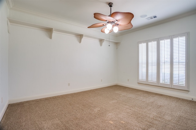 spare room featuring crown molding, carpet floors, and ceiling fan