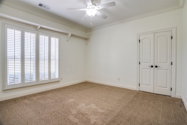 carpeted spare room with ornamental molding and ceiling fan