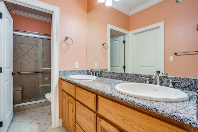 bathroom featuring a shower with shower door, ornamental molding, dual vanity, toilet, and tile patterned flooring