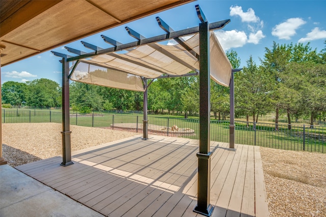 deck featuring a lawn and a pergola