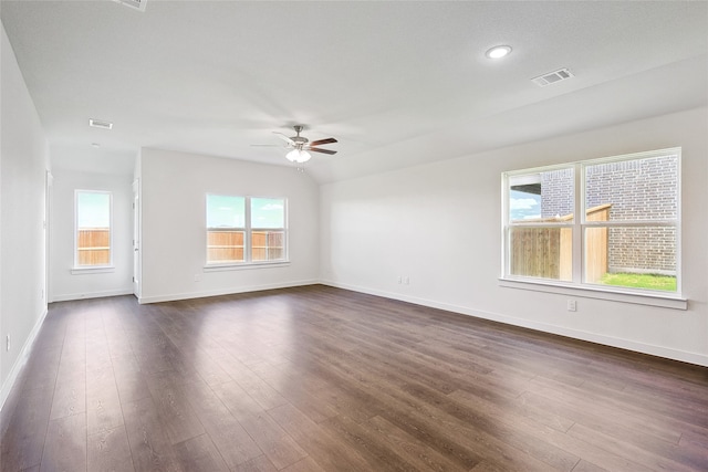 unfurnished room with ceiling fan, vaulted ceiling, and dark hardwood / wood-style flooring