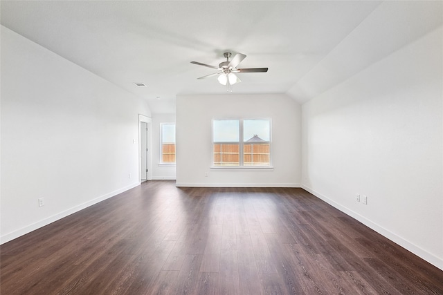 empty room with vaulted ceiling, dark hardwood / wood-style floors, and ceiling fan