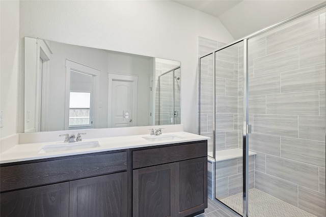 bathroom featuring vanity, vaulted ceiling, and walk in shower