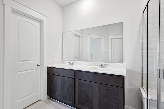 bathroom with vanity, an enclosed shower, and hardwood / wood-style floors