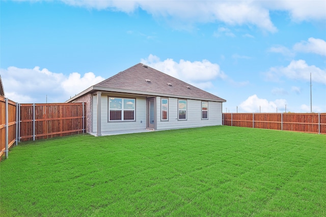 back of house featuring a yard