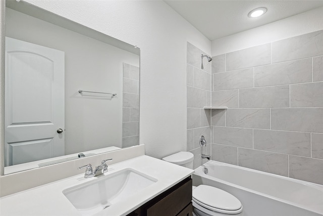 full bathroom with vanity, toilet, and tiled shower / bath combo