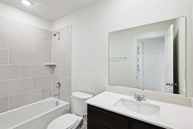 full bathroom featuring toilet, tiled shower / bath combo, and vanity