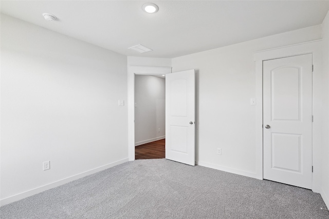 unfurnished bedroom featuring dark colored carpet