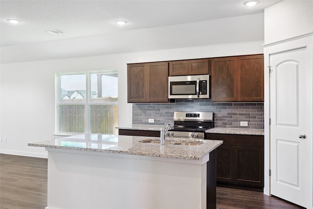 kitchen with stainless steel appliances, dark brown cabinetry, sink, and dark hardwood / wood-style floors