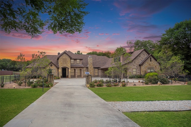 french country home with a lawn