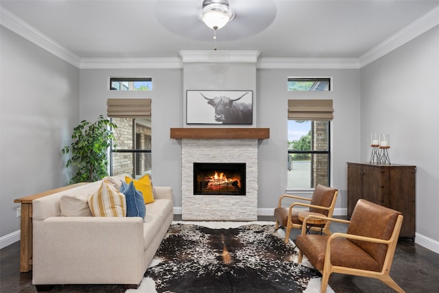 living room featuring a fireplace, ceiling fan, and crown molding