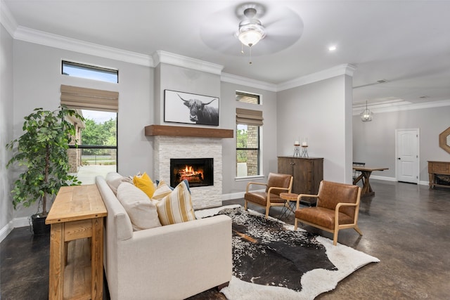 living room featuring ornamental molding, ceiling fan, and a fireplace