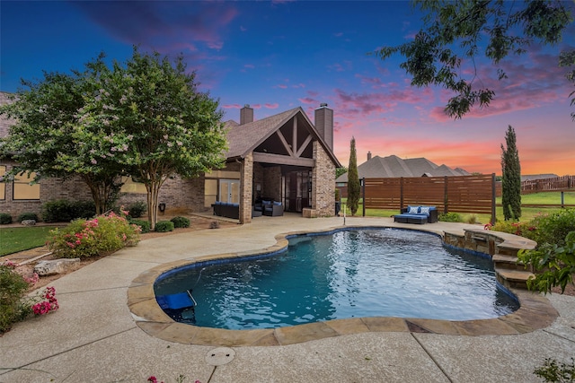 pool at dusk with a patio area