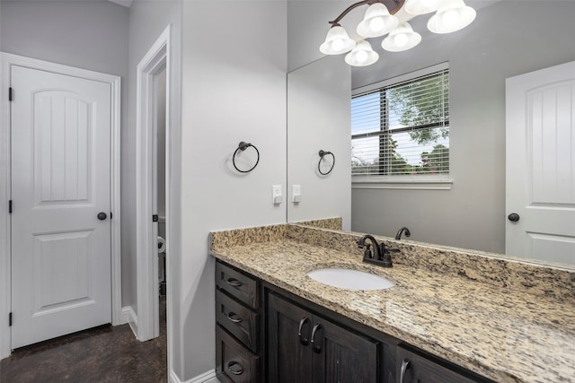 bathroom with vanity and a chandelier