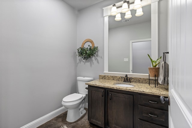 bathroom with toilet and vanity