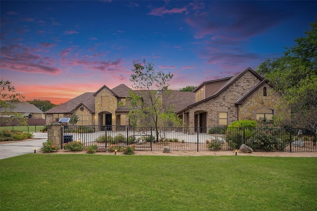 french country home with a lawn