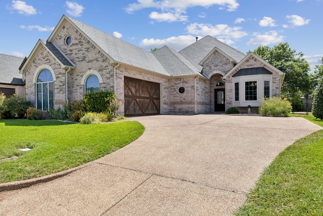 view of front of home with a garage and a front yard