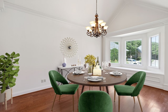 dining space featuring vaulted ceiling, ornamental molding, dark wood-type flooring, and an inviting chandelier