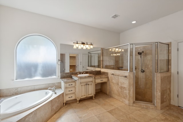 bathroom with vanity and independent shower and bath