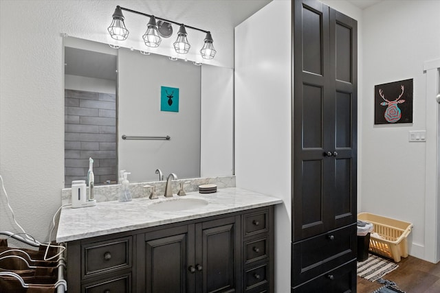 bathroom with hardwood / wood-style floors and vanity