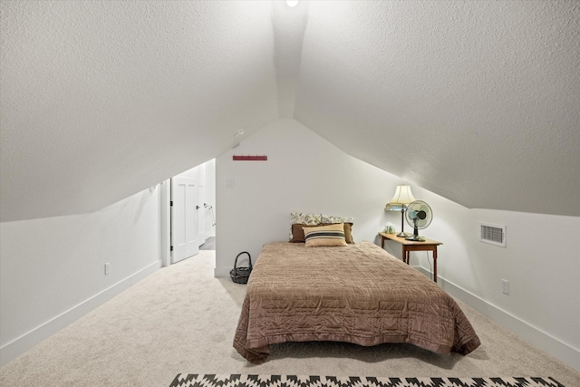 bedroom featuring carpet flooring, a textured ceiling, and vaulted ceiling